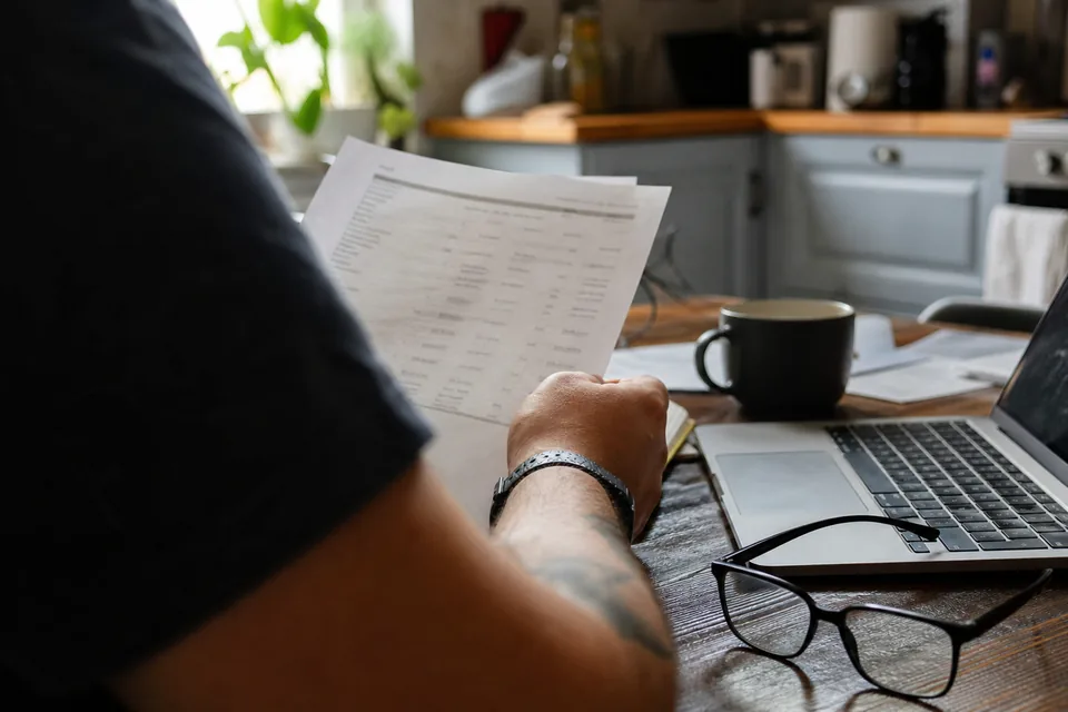Printed bank activity export on a home office table